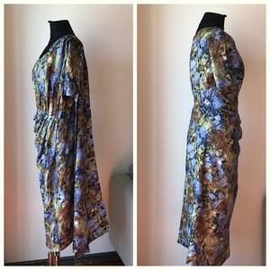 May include: A blue, green, and brown floral print dress with a gathered skirt and short sleeves.