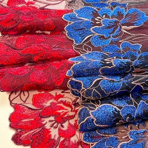 May include: Close-up of floral lace fabric in red and blue. The red lace features a detailed floral pattern, while the blue lace showcases large, embroidered flowers. The intricate designs are set against a dark background, highlighting the vibrant colors and textures.