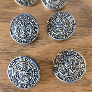 May include: Six silver-toned metal buttons with a raised design of a bird with outstretched wings and the text "DEVS SPES NOSTRA" around the perimeter.
