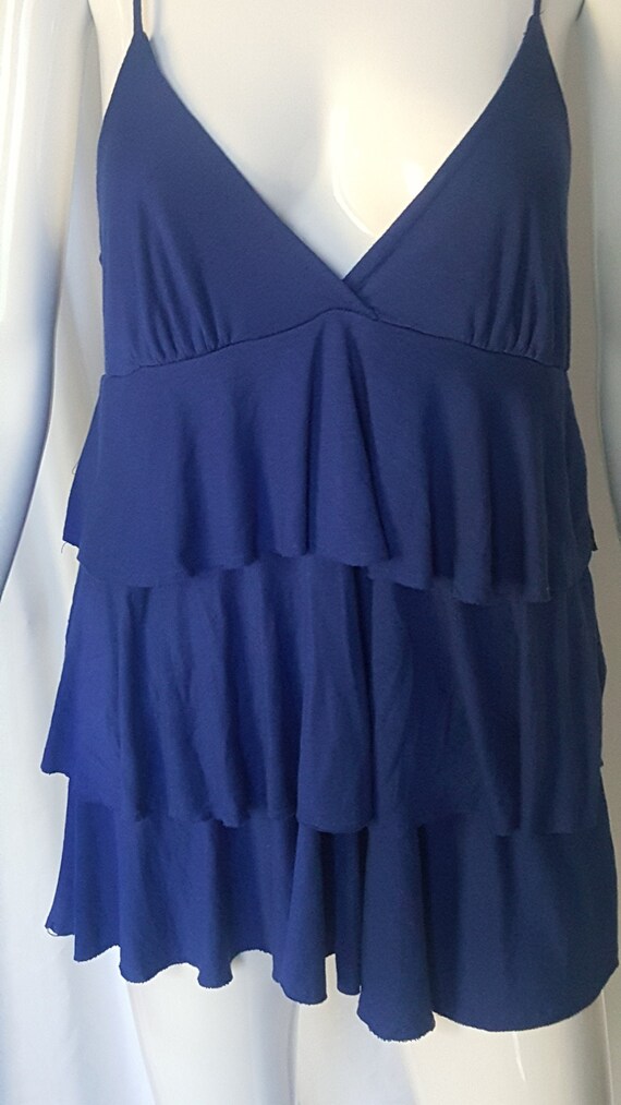Blue Ruffled Tank Under A Blue And Gray Sweater. - Gem