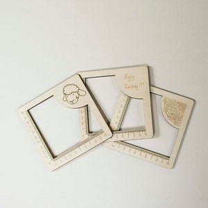 May include: Three wooden knitting gauge tools with a sheep, a swirl design, and the text "Happy Knitting!!!"  Each tool has a ruler on the edge.