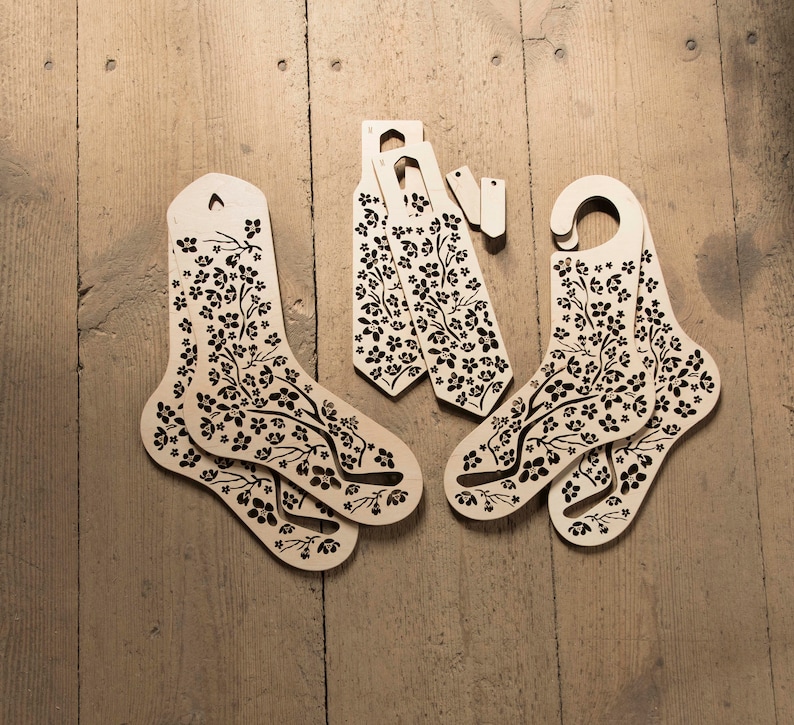May include: Set of six wooden sock forms with a floral pattern. The forms are designed to help keep socks in shape and prevent them from getting stretched out.