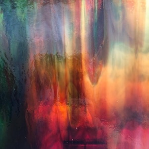 May include: Abstract artwork with a vibrant display of colors. The image features a blend of red, orange, yellow, green, and blue hues, creating a dynamic and visually engaging composition. The colors appear to blend and flow, suggesting movement and depth.
