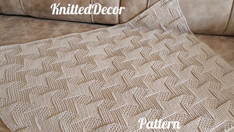 May include: A beige knitted blanket with a geometric pattern. The blanket is rectangular and has a textured surface. The words "Knitted Decor" and "Pattern" are visible on the image.