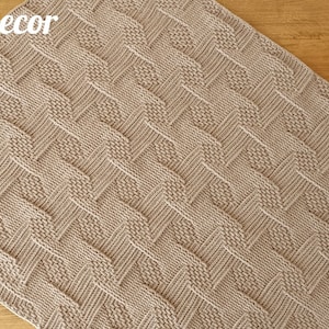 May include: A beige knitted blanket with a woven pattern. The blanket is rectangular and has a textured surface. The words "Knitted Decor" and "Pattern" are visible in the image.