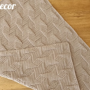 May include: Two beige knitted rectangular items with a textured geometric pattern. The items are displayed on a wooden surface. The text "Knitted Decor" is visible in the upper left corner, and the word "Pattern" is in the lower right corner.