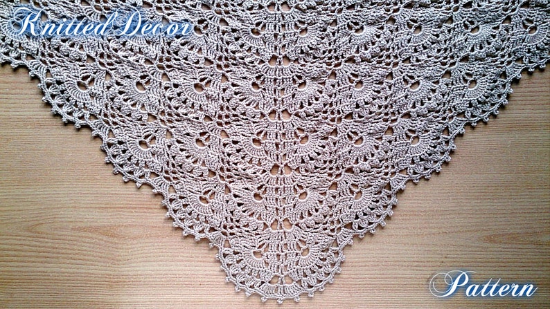 May include: A beige, crocheted shawl with a detailed, openwork pattern. The shawl is triangular, with a scalloped edge. The words "Knitted Decor" and "Pattern" are written in cursive script across the image.
