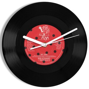 May include: A black vinyl record clock featuring a red label with white polka dots. The label has the text "MY GIRL" and "ROD STEWART" on it. The clock hands are white.