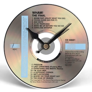May include: A unique clock made from a CD, featuring the album art for Wham!'s "The Final." The clock face displays the album's tracklist and has black clock hands. The CD is set against a white background.