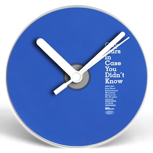 May include: A blue CD with a clock face and white hands. The CD has the text "Colors In Case You Didn't Know" printed on it.