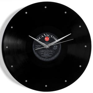 May include: A black vinyl record clock with silver hands and hour markers. The center label features the RCA Victor logo and text from The Monkees album. A unique wall clock for music lovers.