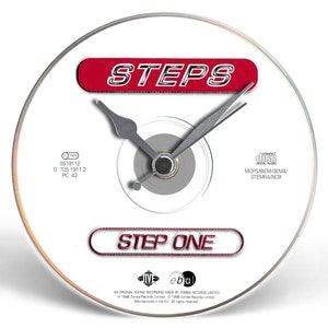 May include: A white CD with a red and silver clock face. The clock face has the words "STEPS" and "STEP ONE" in red. The CD is labelled with the text "0519112", "D: 705 1911.2", "PC: 43", "MOPS/BIEM/GEMA", "STEMRA/NCB", "Jebu", "IN ORIGINAL SOUND RECORDING MADE BY JOMBA RECORDS LIMITED", "1998 Zomba Records Limited", and "Manufactured in the EU. All rights reserved."