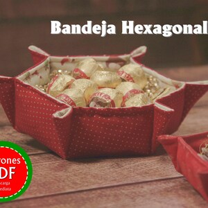 May include: A red hexagonal fabric tray with white polka dots, filled with gold-wrapped chocolates. The tray is on a wooden surface. A smaller red tray with white polka dots is in the background. The text "Patrones PDF Descarga Inmediata" is on a green and red circle.