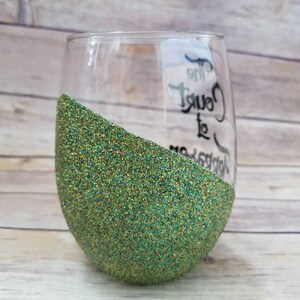 May include: A green glitter wine glass with the text "The  Count to  Happiness" written on the side.