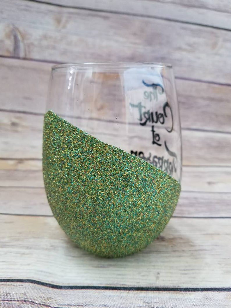 May include: A green glitter wine glass with the text "The  Count to  Happiness" written on the side.