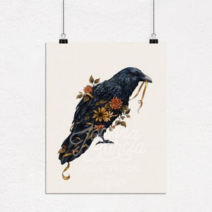 May include: A black raven with a gold ribbon in its beak, surrounded by orange, yellow, and brown flowers. The raven is perched on a branch with its wings spread out. The background is a light cream color. The image is titled "Joy Felicia Illustration & Design".