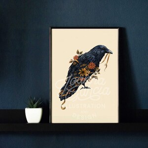May include: A black raven with a yellow ribbon in its beak, surrounded by orange and yellow flowers. The raven is perched on a branch with its wings spread out. The background is a light cream color. The image is titled "Joanna Garcia Illustration and Design".