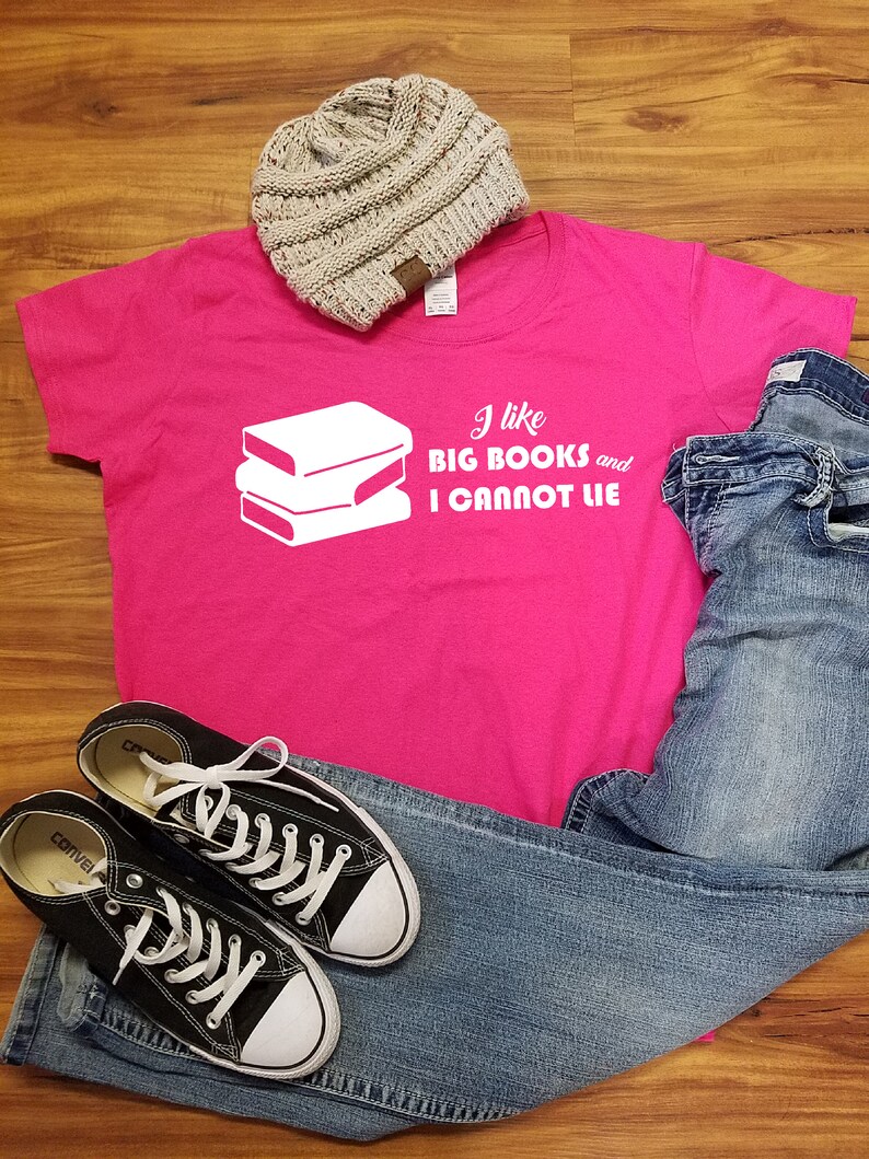 May include: Pink t-shirt with a white graphic of stacked books and the text "I like big books and I cannot lie."