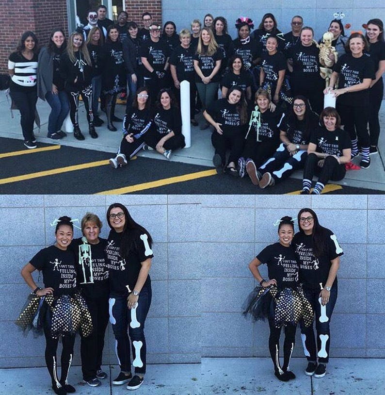 May include: A group of people dressed in black shirts with a skeleton graphic and the text "I got this feeling inside my bones". Some people are wearing skeleton costumes and accessories. The group is standing in front of a brick wall.