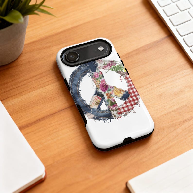 White phone case with a peace sign made of denim and floral fabric.