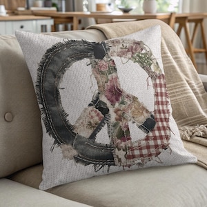 Patchwork peace sign pillow on a couch with a blanket.