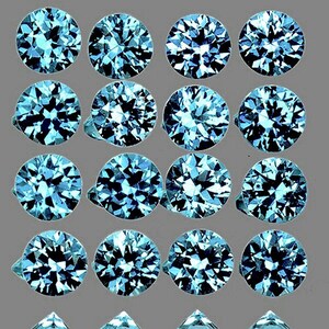 May include: A collection of 16 round, faceted, blue gemstones. The gemstones are arranged in a grid pattern.