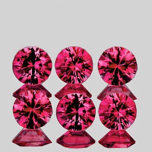 May include: Six faceted, round, hot pink gemstones are arranged in two rows of three. Each gem sits atop a small, triangular base. The gems have a brilliant cut, reflecting light and creating a sparkling effect. The background is a soft, neutral gray.
