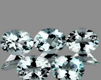 May include: Five oval-shaped aquamarine gemstones, each with a light blue color and a faceted cut.