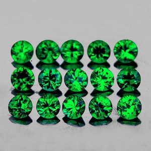 May include: A collection of 12 round, faceted, green gemstones. The gemstones are arranged in four rows of three, with each gemstone reflecting light.