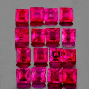 May include: A collection of square-cut, vibrant pink gemstones. The gems are arranged in rows and columns, reflecting light and showcasing their facets. The polished surfaces create a dazzling display of color and brilliance. The gemstones are set against a neutral background.