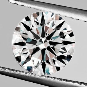 May include: A round, clear diamond with a star-shaped pattern in the center. The diamond is held in place by a pair of tweezers.