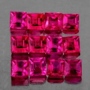 Pode incluir: Uma coleção de pedras preciosas rosa vibrantes, cortadas em forma quadrada, dispostas em uma grade. As gemas têm alta clareza e refletem a luz, mostrando suas facetas. A apresentação geral sugere joias ou materiais de pedras preciosas.