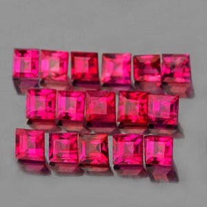 May include: A collection of square-cut, vibrant pink gemstones. The gems are arranged in rows, showcasing their facets and intense color. The polished surfaces reflect light, creating a dazzling display of radiant pink hues.