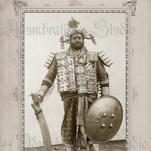 May include: A black and white photo of a man wearing a spiky armor and holding a sword and shield. He is standing in a field.