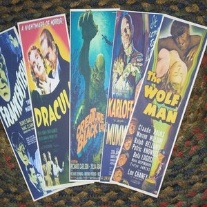 May include: Five vintage movie posters featuring classic horror films. The posters are in black, white, and color and feature images of Frankenstein, Dracula, the Creature from the Black Lagoon, the Mummy, and the Wolfman. The posters are all in good condition and would be a great addition to any horror movie fan's collection.