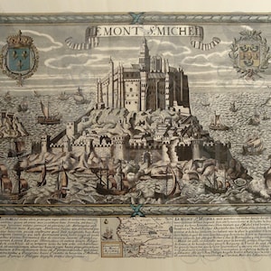May include: An antique-style engraved print depicting Le Mont Saint-Michel, featuring the abbey atop a rocky island surrounded by sailing ships. The image includes heraldic crests, a decorative border, and detailed text blocks at the bottom.