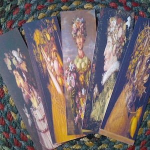 May include: Five bookmarks featuring colorful, detailed illustrations of human figures with floral and foliage elements. The figures are depicted in a whimsical style, with exaggerated features and intricate details.