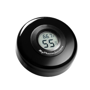 May include: A black round humidity and temperature monitor with a digital display showing 66.7 degrees Fahrenheit and 55% humidity. The monitor has the text "MyPharmJar.com" printed on it.