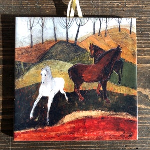 May include: A painting depicting three horses in a field. The horses are brown, white, and black. The background features a landscape with trees and hills.