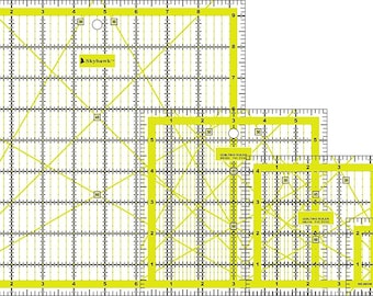 May include: A set of yellow and clear quilting rulers in various sizes. Each ruler has a grid pattern with measurements in inches and diagonal lines for angle guides. The brand name "Skyhawk" is visible on the largest ruler.