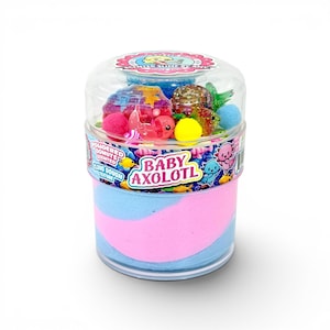 May include: A clear plastic container filled with blue and pink swirled slime. The container is decorated with the words "Baby Axolotl" and various small, colorful toys, including axolotl figures, glitter, and small balls. The top of the container has the words "Scented Slime By Any".