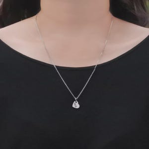 Belle Fever heart-shaped pendant from missing piece set worn as a necklace, styled against skin — minimal and meaningful for couples or anniversaries.