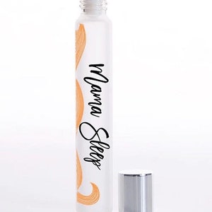 May include: A clear glass roller bottle with a silver cap and a white label that says "Mama Sleep". The label has a peach-coloured design.
