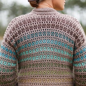 May include: A brown, green and blue crocheted cardigan with a textured stitch pattern.