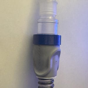 May include: A gray and blue medical hose connector with the text "ClimateLine A" printed on the side.