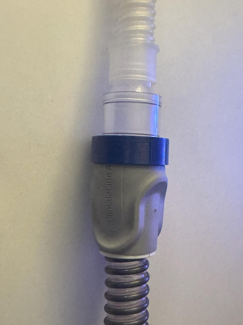 May include: A gray and blue medical hose connector with the text "ClimateLine A" printed on the side.