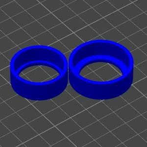 May include: Two blue, cylindrical objects with a hollow center are displayed. The objects are similar in shape, but one is smaller than the other. The objects are set against a gray grid background.