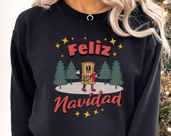 May include: Black sweatshirt with a Christmas-themed design featuring a cartoon stick of wood with a red cup and the text "Feliz Navidad" in Spanish.