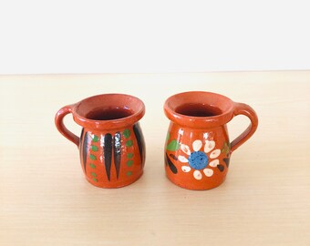 Two small mini ceramic vases in the color orange