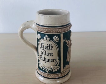 small vintage beer mug with relief, beige green